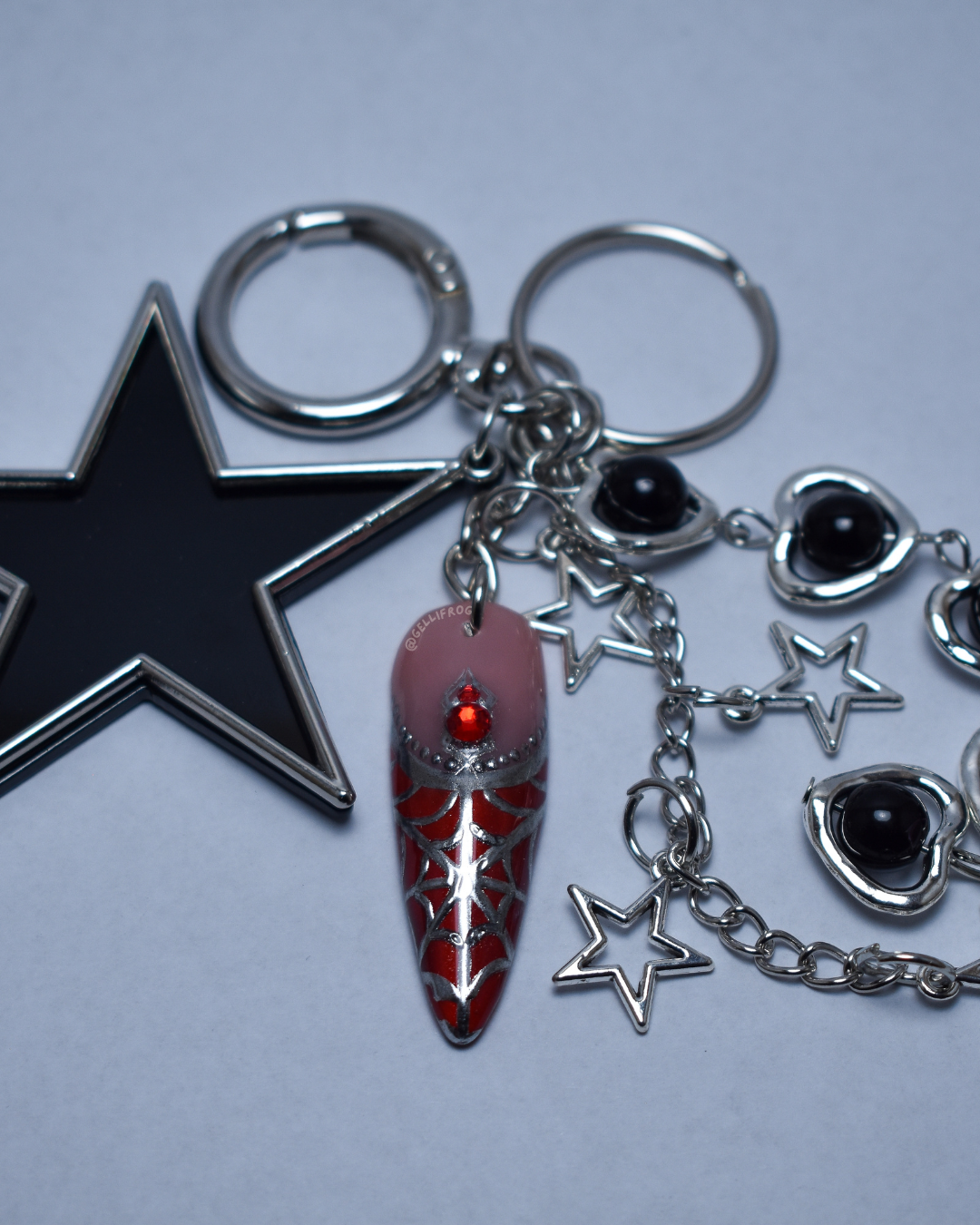 Spider Bite hand-painted red cat eye spiderweb nail keychain by Gellifrog with NFC